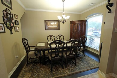 Formal Dining Area with wood flooring and natural lighting.