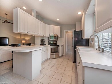 Kitchen with breakfast bar and newer appliances.