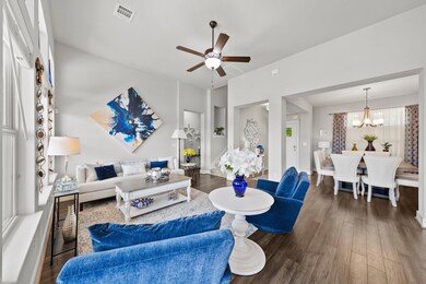 Living area with ceiling fan, wood finished floor
