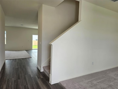 Stairs with wood finished floors and baseboards