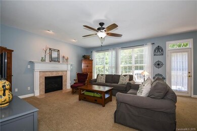 Family room with gas log fireplace and tons of natural light