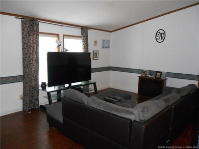 Family Room with vaulted ceilings and laminate woo