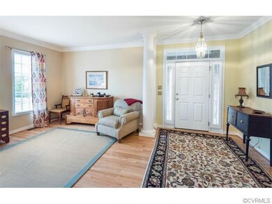 Foyer and living room with hardwood floors, crown 
