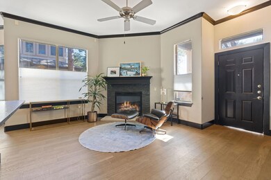 Foyer featuring a ceiling fan, a stone fireplace,