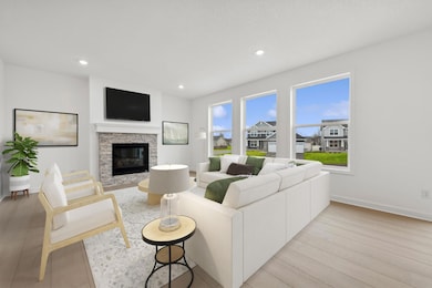 (Photo of similar home, finishes will vary)  Notice the stunning natural light pouring into this spacious family room. Plus, the beautiful gas fireplace.