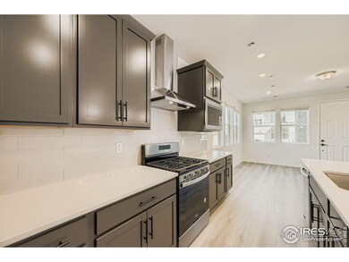 Kitchen with a gas range and chimney hood!