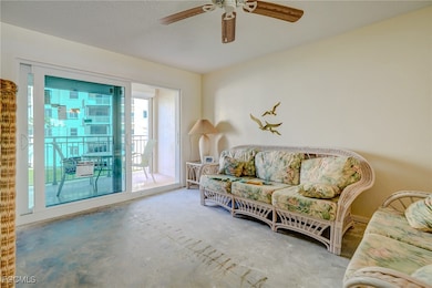 Sitting room featuring a textured ceiling, a ceiling fan, and unfinished concrete floors