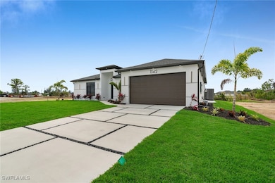 View of front of house with driveway, a front lawn