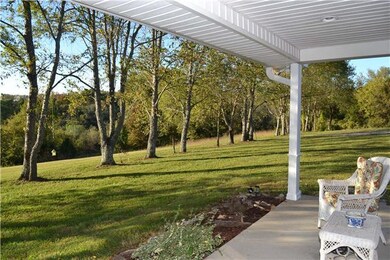 AREA OF THE FRONT PORCH LOCATED OFF OF THE MASTER BEDROOM DOOR! STEP OUTSIDE  ON THE FRONT PORCH TO DECOMPRESS BY LISTENING TO THE SOUNDS OF NATURE.