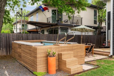 View of patio featuring a balcony and fence