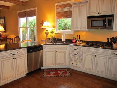Glazed cabinetry, stainless appliances, and gas co