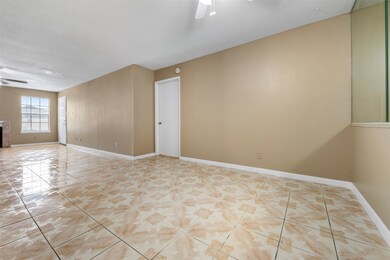 Bright room with beige walls and tiled floors, fea