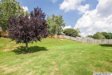 The back yard is totally privacy fenced and offers some large trees for shade.