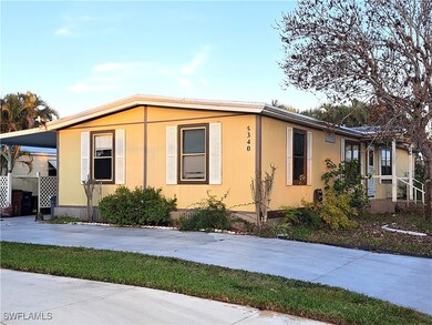 View of front facade with a carport