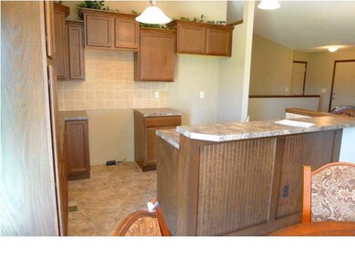KITCHEN WITH UPGRADED CABINETS AND EATING BAR