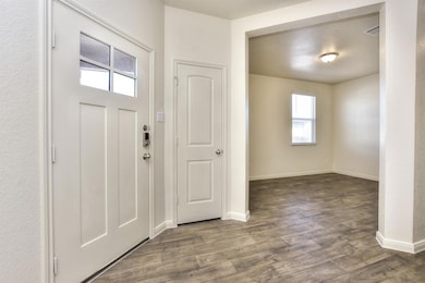 Foyer featuring baseboards, visible vents, and wo