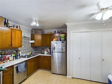 Kitchen with stainless steel appliances, light cou