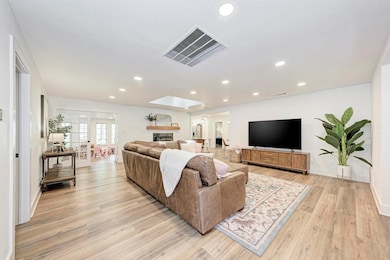 Living room featuring light wood-type flooring, b