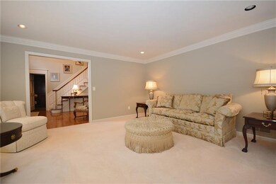 Neutral carpeting in traditional living room.
