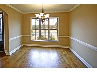 Spacious dining room with chair rail and crown mol
