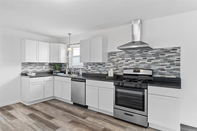 Kitchen with White Shaker Style Cabinetry and Glas