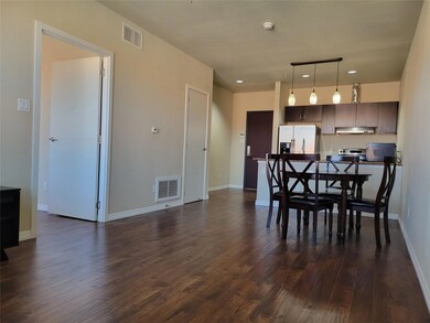 Dining space with dark wood-type flooring