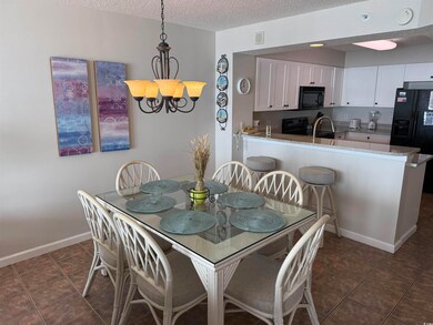 Dining room with a textured ceiling, visible vents