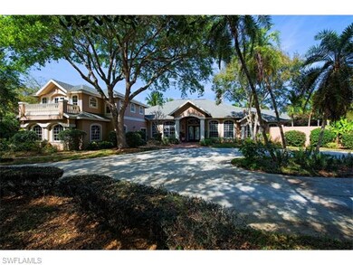 Front view of this beautiful home with mature cust