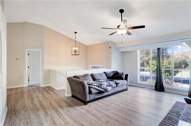 Living room featuring ceiling fan with notable cha