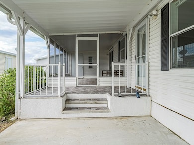 View of patio featuring a sunroom