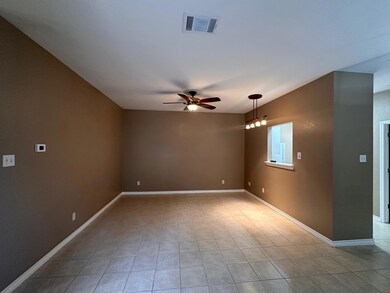 Tiled empty room featuring visible vents, a ceili