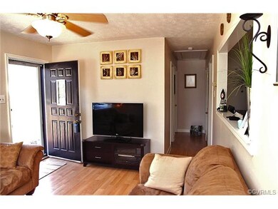 family room is overlooked by the kitchen through t