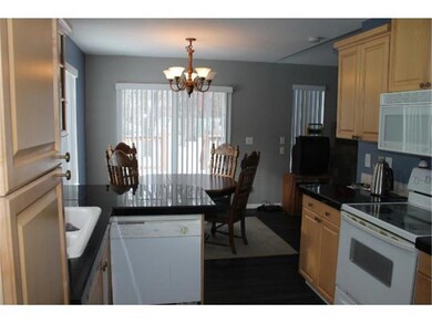 Kitchen area looking into dining area and out to b