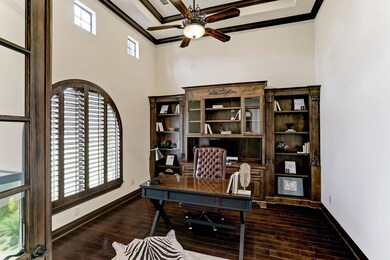 Off the entry, the gorgeous study provides a stately work-from-home space surrounded by bright windows, French doors, double tray ceilings and bespoke cabinetry.