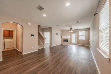 Unfurnished living room with washer / clothes dryer, recessed lighting, a tile fireplace, dark wood finished floors, and ceiling fan