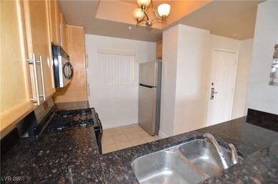 Kitchen with an inviting chandelier, appliances wi