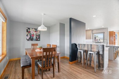 Dining space with light wood-style flooring and baseboards