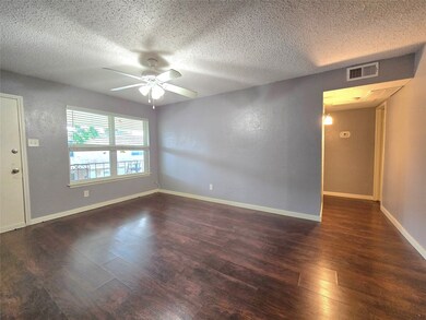 Bright living room with light purple walls, dark w