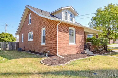 View of side of property featuring brick siding