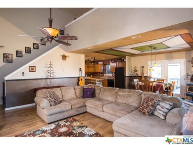 large livingroom open to kitchen, view out back wi