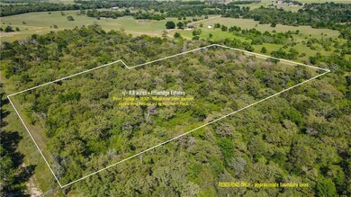 Wooded acreage with small clearings and paved coun
