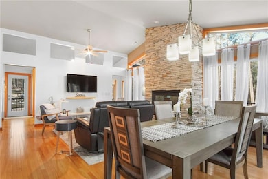 Dining room featuring a ceiling fan, a fireplace, 