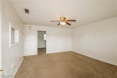 Unfurnished room featuring carpet, a textured ceil