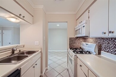 Kitchen featuring white appliances, light tile pa