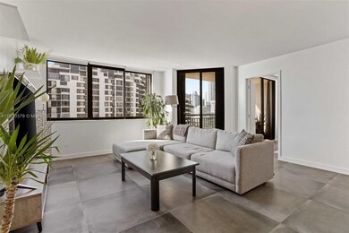 The spacious living area seamlessly connects to a stylish kitchen with high-end finishes, making it perfect for entertaining. Relax while enjoying the picturesque scenery or step onto the balcony for a closer look at the serene waterfront.