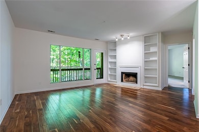 Living room with wood burning fireplace and hardwo