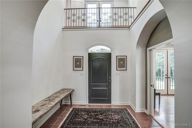 Entryway featuring french doors, a high ceiling, and tile flooring