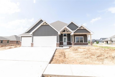 Craftsman-style house with board and batten siding, an attached garage, concrete driveway, and brick siding