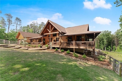 Log home featuring roof with shingles