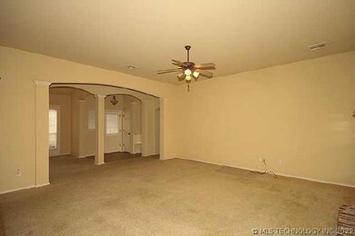 Living room shows  widearched entry